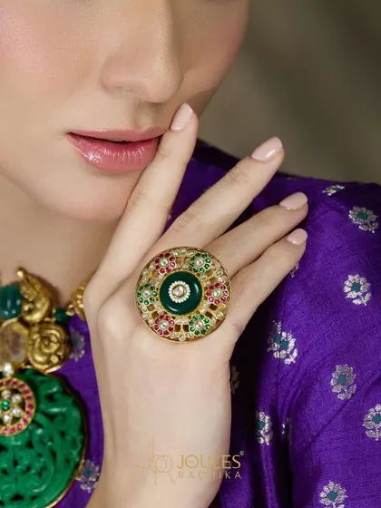 Aalayaa rings, because beauty feels complete when celebrated. This is a close-up of our large, circular statement ring with a central emerald and intricate enamel work.