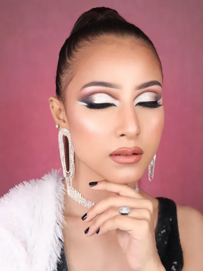 A creative and dramatic eye makeup look with a sharp white graphic liner against a smokey background. This is fashion makeup at its best.