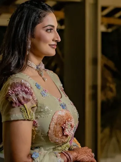 A side profile of bride Shree in her pastel Rahul Mishra lehenga. The delicate 3D floral embroidery is a signature of the designer and looks beautiful on her.