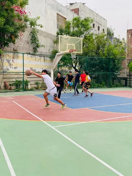 A player drives to the hoop for a layup, showcasing offensive aggression.