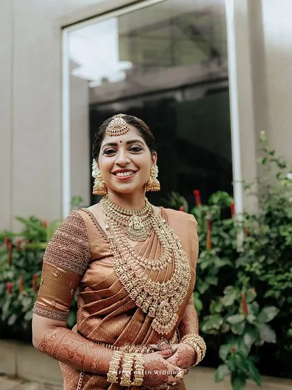 A lovely portrait of the bride, her smile warm and genuine, her traditional jewelry shining.