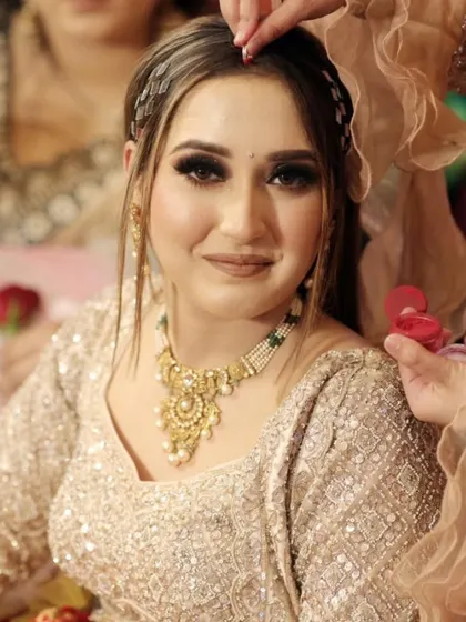 A quiet moment during the bridal preparations. The final touches being put in place are part of the tradition and anticipation that build up to the main ceremony.