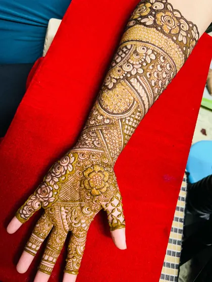 A beautiful non-bridal Indian design with full coverage on one arm. The patterns are a mix of floral and traditional motifs.