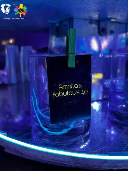 A personalized glass tag for "Amrita's fabulous 40," adding a special touch to her milestone birthday celebration.