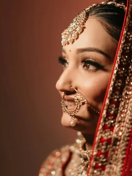 A dramatic and beautiful close-up of the bride, Mehak. The lighting and her expression create a powerful and emotive bridal portrait.