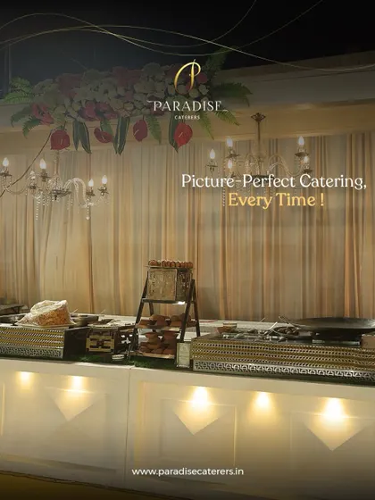 Picture-perfect catering, every time. An elegant buffet counter with a chandelier overhead, showcasing our attention to detail in creating a sophisticated ambiance.