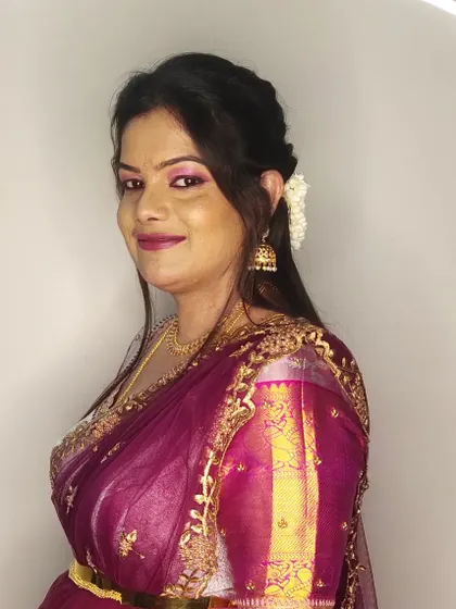 A smiling portrait of Kalyani, ready for the wedding festivities. The makeup is glamorous yet elegant.