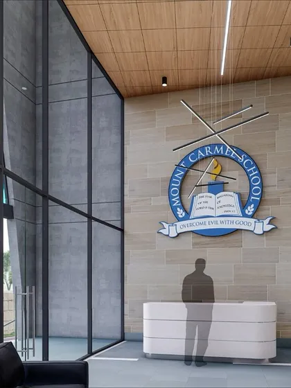 A render of the school's reception area, showcasing the double-height entrance, the school's emblem on a stone-clad wall, and a glimpse of the stained glass, illustrating our vision for a grand and welcoming entry.