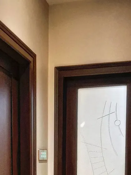 This image shows a touch panel seamlessly integrated into a wooden-paneled wall, proving that our technology can be camouflaged to maintain the integrity of your interior design.