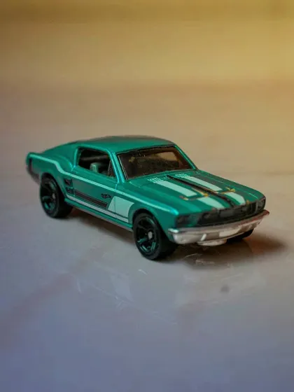A detailed shot of a green Hot Wheels model of a classic Ford Mustang. This photo showcases the art of miniature and collectible photography.