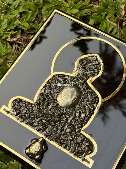 This close-up shows the detail of the Mahaveer Swami artwork. The silhouette is filled with pyrite, and a small turtle is placed at the bottom, symbolizing wisdom and stability.