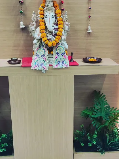 For this office pooja or prayer area, I added two small artificial plant arrangements on either side of the altar. This helps to create a calm and complete look for the sacred space.