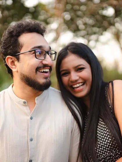 The pure joy on their faces is infectious. This close-up captures a moment of shared happiness, highlighting their connection and carefree spirits during their outdoor photoshoot.