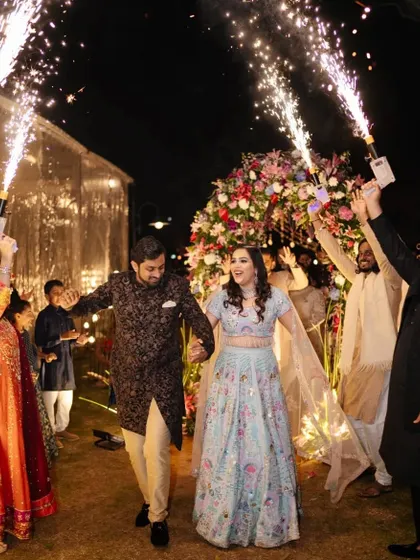 Capturing the pure joy of the celebration is what we do best. Here, the happy couple makes a grand entrance to their Sangeet, surrounded by friends, family, and a shower of sparklers, kicking off a night of music and dance.