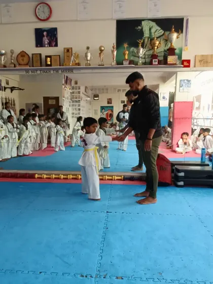 A young girl receives her yellow belt.