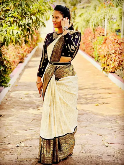 A duplicate image of a client posing in her Kanjeevaram saree and custom blouse.