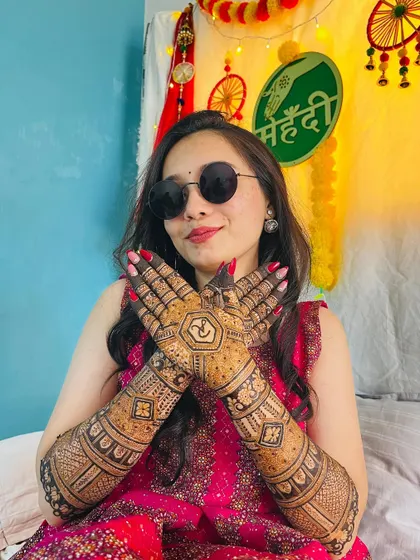A happy bride with a cool attitude. Her sunglasses and smile, paired with her stunningly intricate mehendi, create a perfect picture of a modern bride.