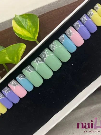 Soft pastels meet sharp geometry in this square-shaped press-on set. Each nail has a different pastel color with a cool silver geometric design at the cuticle.