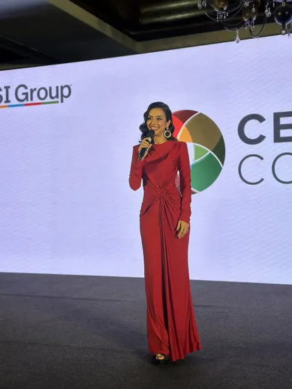 Another shot of this powerful emcee look. The lighting catches the beautiful sheen on her skin and the elegant structure of her hairstyle. This makeup is designed to look flawless under stage lights.