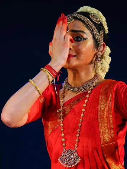 An intense moment of abhinaya, where the expression conveys deep emotion and spiritual longing. This is from a piece describing the devotee's overwhelming feelings for Lord Venkateshwara.