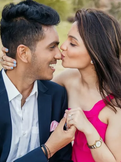A sweet kiss. The makeup is subtle and romantic, ensuring she looks and feels beautiful in these cherished, candid moments.