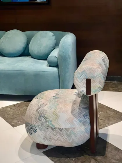 We customized this chubby slipper chair for a hotel lobby to provide a comfortable and stylish seating option. The chair's unique shape and patterned fabric make it a pretty and inviting piece of accent furniture.