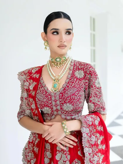 The magic is in the details. This close-up on a Jayanti Reddy bridal look showcases how I layer heritage jewelry to complement the intricate embroidery of the blouse. Every element, from the pearl strings to the pop of turquoise, is chosen to build a rich, regal narrative.
