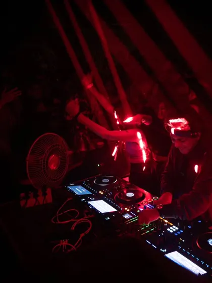 A dark, moody shot from Magique, Bangalore, with red lights cutting through the darkness. The focus is purely on the music and the dance.