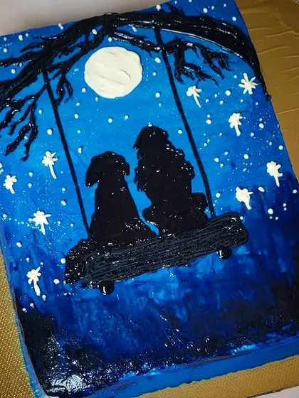 Just me and you. A hand-painted cake showing the silhouette of two dogs on a swing under the moonlight. Perfect for the dog lover.