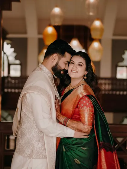 A stunning portrait of a couple during their engagement ceremony in Nashik. The rich colors of her saree and the elegant decor create a royal feel.