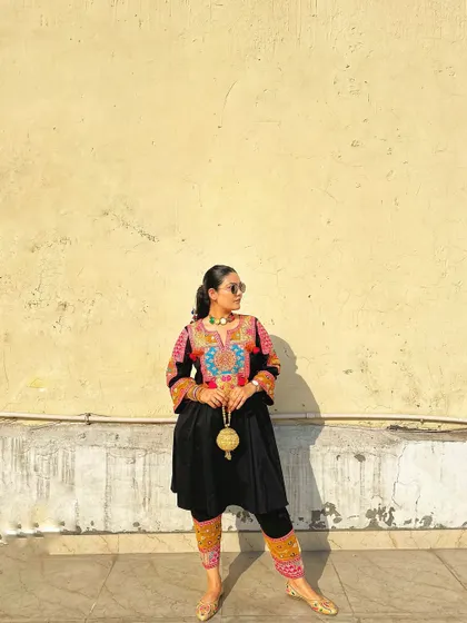 The intricate and colorful embroidery on the neckline and cuffs makes this black suit set truly special.