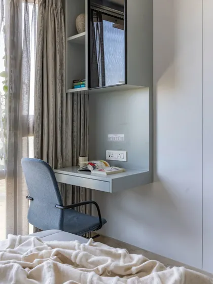 The sleek study nook by the window in the space-themed room encourages learning under natural light, making it a safe and inspiring space.