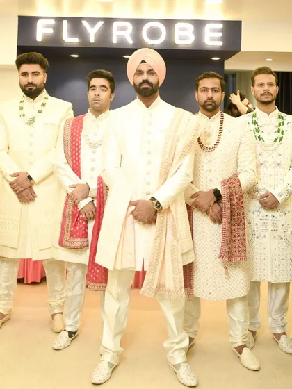 The groom and his groomsmen, all dressed in coordinated ivory sherwanis from our collection. We can style your entire wedding party.