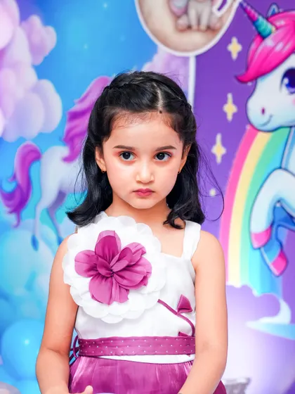A magical 'Mermaid' themed birthday party, with shimmering blue and green decor, seashell props, and mermaid cutouts, creating an enchanting underwater world.