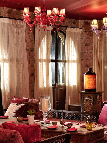 Another view of our sunlit lounge area. The combination of rich reds, intricate woodwork, and elegant lighting makes it a perfect spot for a royal feast.
