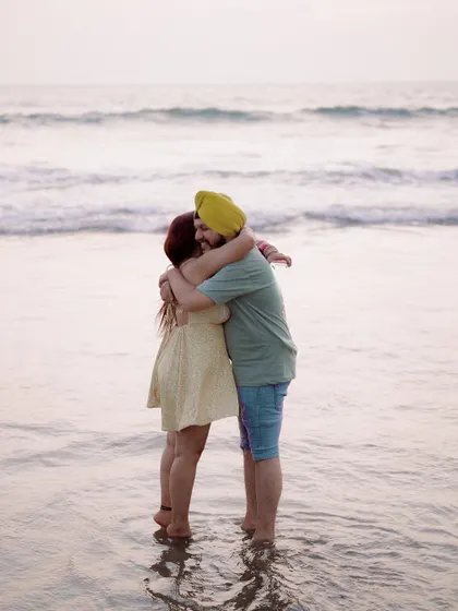 A warm hug in the waves. This photo perfectly captures the feeling of finding comfort and home in each other's arms.