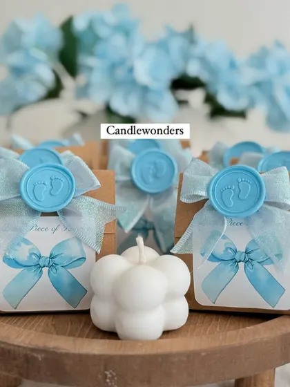 Another angle of the baby shower favors, with blue flowers in the background to match the theme.