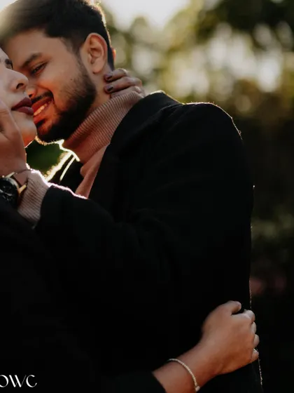 A close-up, sun-flared shot of a couple about to kiss, capturing the anticipation and romance of the moment.