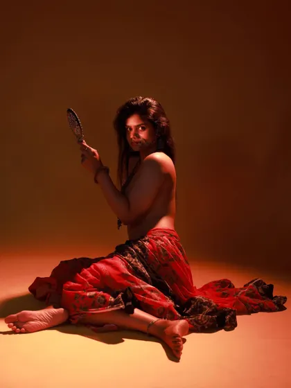 A direct-to-camera look from the same series. The model's expression is powerful, and the dramatic lighting enhances the mood.
