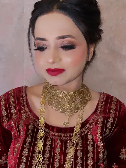 A look created for our bride as per her demand. This photo, taken in low light, still shows the beautiful details of the eye makeup and the rich red lip.