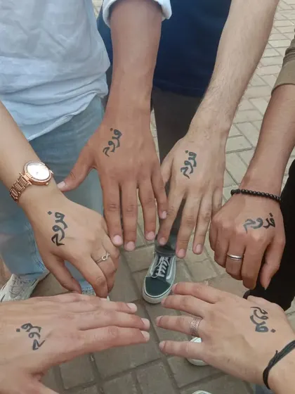 Group tattoos are a great way to celebrate friendship. I painted the word "Froog" in a beautiful script for this group of friends at a college fest.
