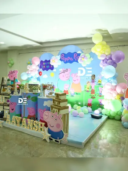 A different angle of Aayansh's Peppa Pig party, showing the layout of the stage and the placement of the character cutouts.