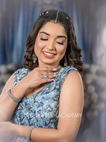 A close-up of the model smiling, with her eyes closed. This highlights the soft pink eyeshadow and the beautiful, dewy finish on her skin.