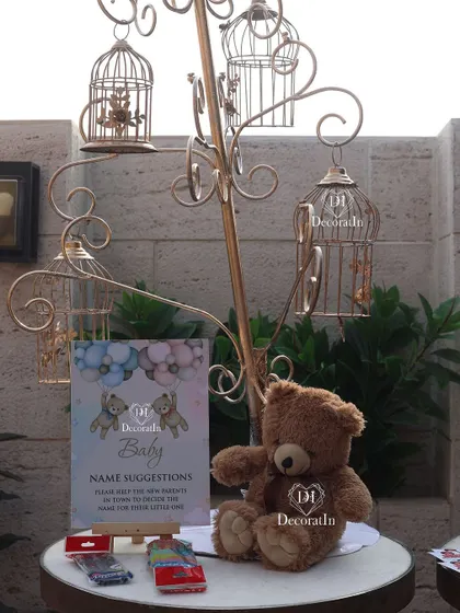 The full name suggestion station, with a decorative birdcage tree for hanging the cards.