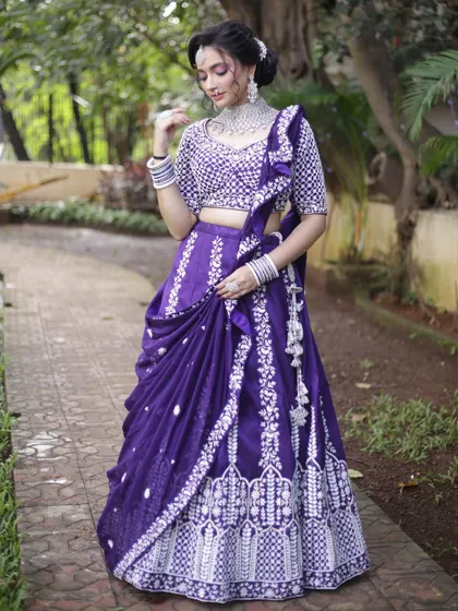 A gorgeous purple lehenga with heavy white embroidery and a pre-draped dupatta. This is a hassle-free, stylish option for any wedding guest or bridesmaid.