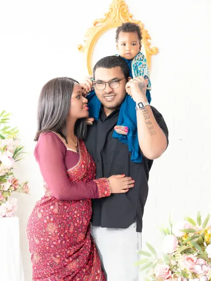 A beautiful family portrait showcasing their love and connection. The mother's traditional saree adds a touch of elegance to this timeless photo.