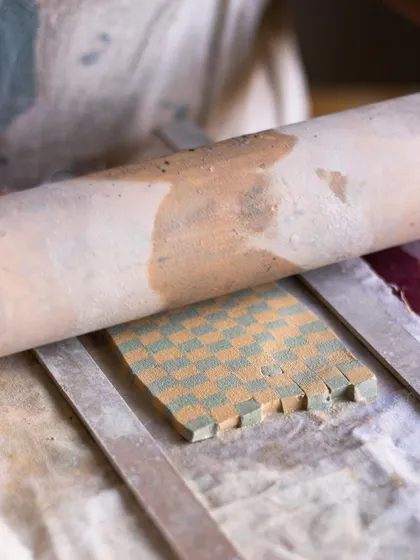 A glimpse into our Nerikomi workshop, showing how colored clay is layered to create a checkerboard pattern. This technique is taught by our resident master, Rajeev.