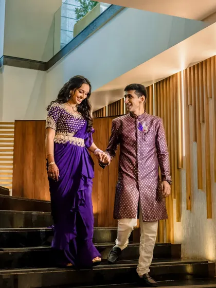 A candid moment of the couple walking down a staircase, hand in hand. Their shared smile and easy stride capture the beginning of their journey together in a natural, unposed way.