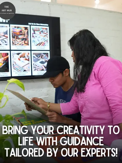 An instructor points out details on a reference board while guiding a student. This personalized feedback helps students understand complex concepts and improve their work.
