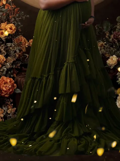 A detail shot of the beautiful, layered green gown against a floral background. I pay close attention to styling and details to make every maternity photoshoot unique.
